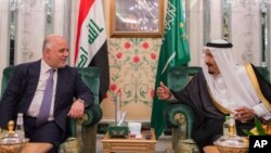 FILE - Iraqi Prime Minister Haider al-Abadi, left, meets with Saudi King Salman in Jiddah, Saudi Arabia, June 19, 2017.