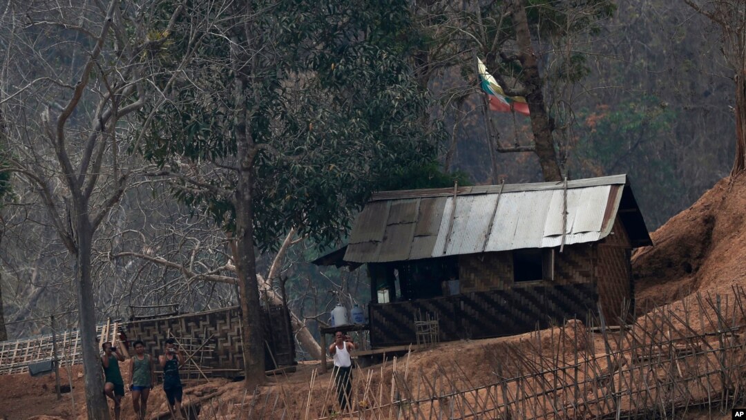 FILE - In this March 30, 2021, photo, Myanmar soldiers stand at a small army camp along the river bank near the border of Myanmar and Thailand. Ethnic Karen guerrillas said they captured the Myanmar army base Tuesday, April 27, 2021.