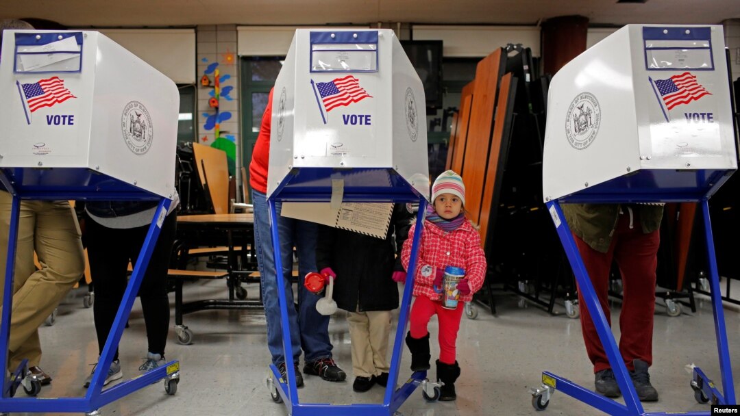 Myla Gibson, 3, waits as her father Ken Gibson fills out a ballot for the U.S presidential election at the James Weldon Johnson school in the East Harlem neighborhood of Manhattan, New York City, Nov 8, 2016. President Donald Trump claims that up to 5 million votes were cast illegally in the November election, costing him the popular vote.