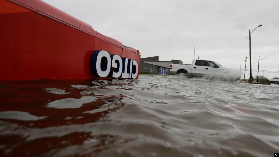 FILE - The roof of a gas station sits in flood waters in the wake of Hurricane Harvey in Aransas Pass, Texas, Aug. 26, 2017. 
