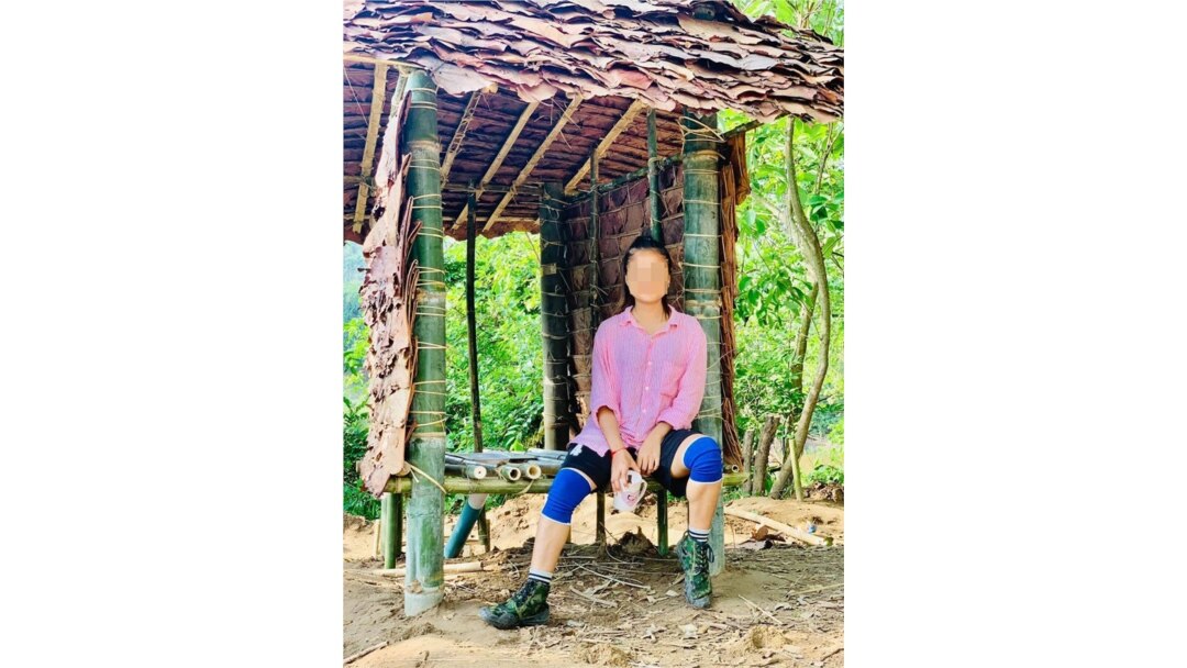 “I never dreamed that I would be sleeping in a roofless shelter or using a makeshift toilet,” said Gue Gue, shown at the toilet she helped build. Source: courtesy of Gue Gue