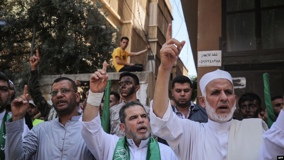 Palestinian Hamas supporters take part in a protest against Israel's plan to annex parts of the occupied West Bank, in Khan Yunis in the southern Gaza Strip on June 26, 2020.