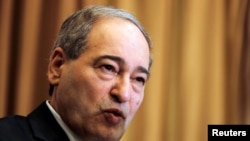 FILE - Syria's Deputy Foreign Minister Faisal al-Mekdad speaks during a news conference in Damascus, Syria, March 10, 2018. 