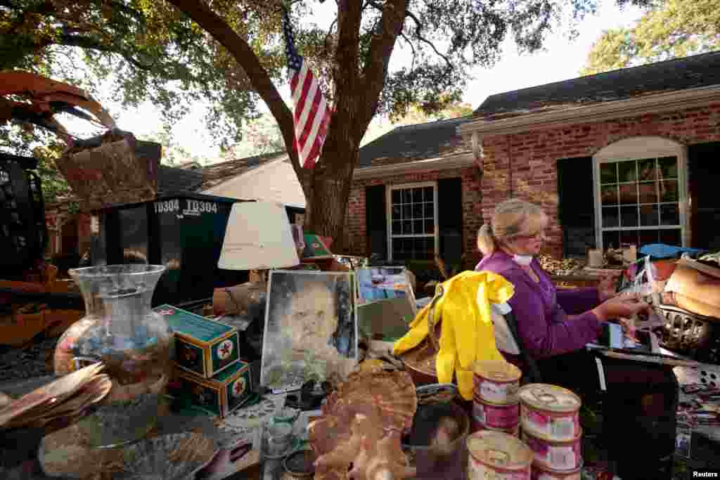 Ginger Benfield saves family photos in the aftermath of tropical storm Harvey in west Houston, Texas, Sep. 11, 2017.