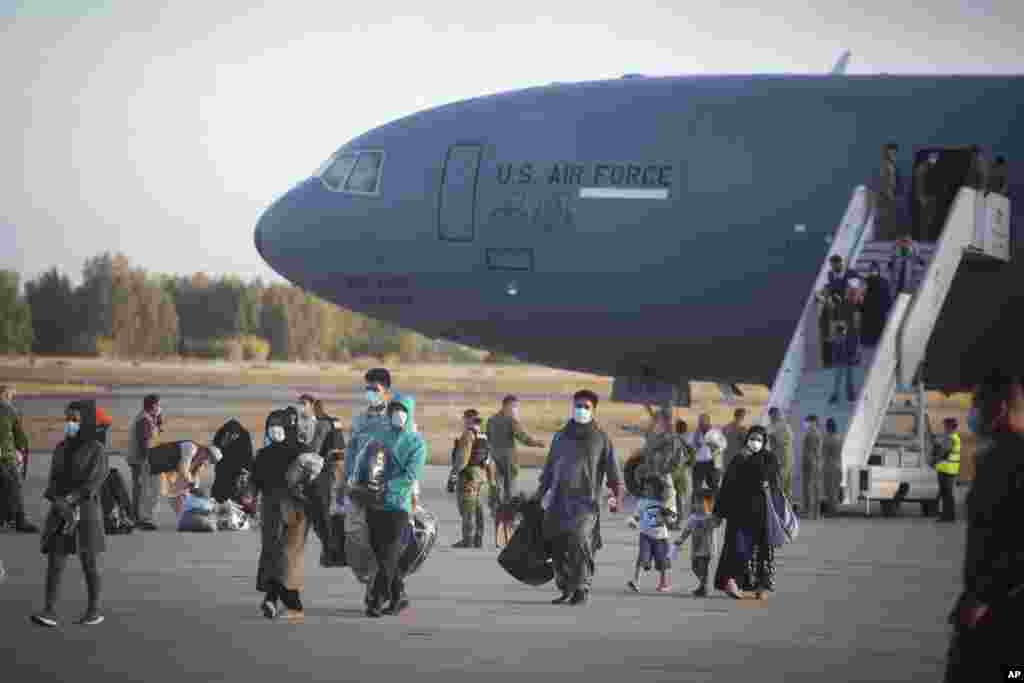Evacuees from Afghanistan disembark from a U.S. airforce plane at the Naval Station in Rota, southern Spain. The United States completed its withdrawal from Afghanistan, ending America's longest war.