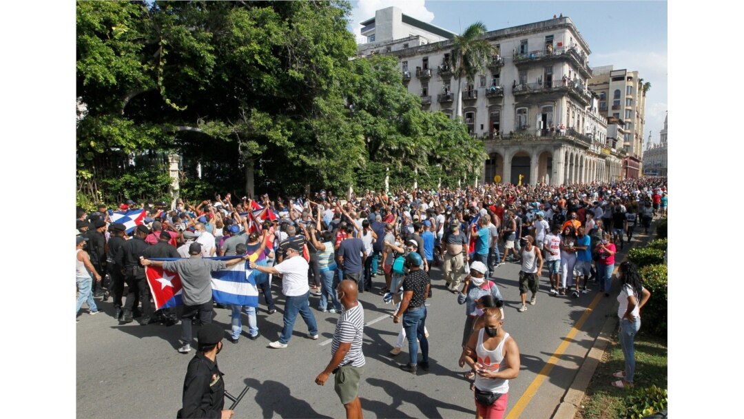 Demonstrators clash during protests against and in support of the government, in Havana, July 12, 2021.
