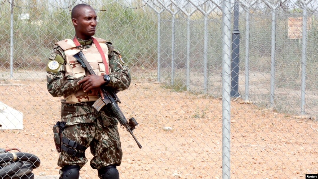 A member of the security forces stands guard at the airport as Ivory Coast Minister of Defense Alain-Richard Donwahi arrives to speak with mutinous soldiers in Bouake, Ivory Coast, Jan. 13, 2017.