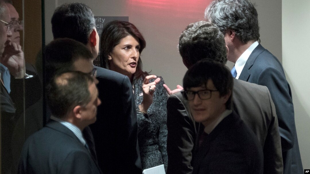 U.S. Ambassador to the United Nations Nikki Haley, center, confers with members of the Security Council before a scheduled vote on a resolution demanding a 30-day humanitarian cease-fire across Syria, Feb. 24, 2018.