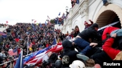 FILE - Supporters of then-President Donald Trump storm the U.S. Capitol building to contest the certification of the 2020 U.S. presidential election results by the U.S. Congress, in Washington, Jan. 6, 2021.
