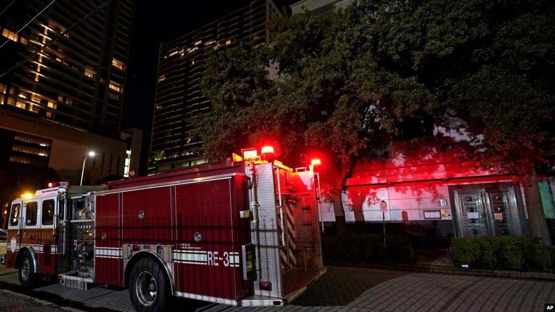 A firetruck is positioned outside the Chinese Consulate, July 22, 2020, in Houston. Witnesses said that people were burning paper in what appeared to be trash cans, according to police.