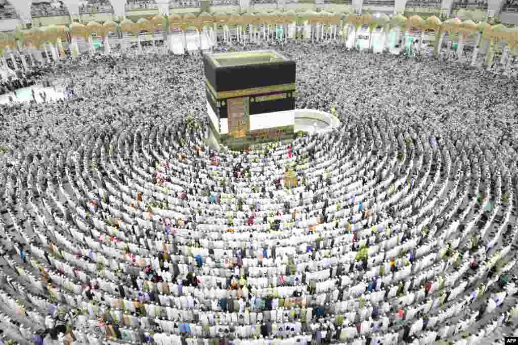 Muslim worshipers perform prayers around the Kaaba, Islam's holiest shrine, at the Grand Mosque in Saudi Arabia's holy city of Mecca, Aug. 15, 2018, prior to the start of the annual Hajj pilgrimage in the holy city.