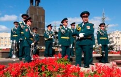 FILE - In this grab taken from a footage provided by the ROSATOM press service, a Russian military band prepares to attend the funerals of 5 Russian nuclear engineers, Aug. 12, 2019.