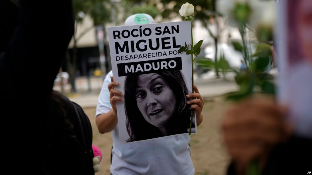 ARCHIVO - Una manifestante opositora sostiene un cartel con la imagen de la activista Rocío San Miguel durante una protesta en Caracas, el 18 de julio de 2024.