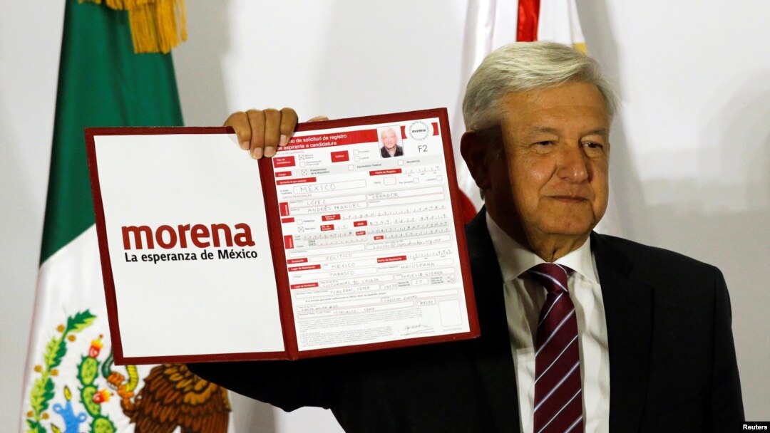Mexican presidential candidate Andres Manuel Lopez Obrador of the National Regeneration Movement (MORENA), shows a document during his registration for the July 2018 presidential election, in Mexico City, Dec. 12, 2017