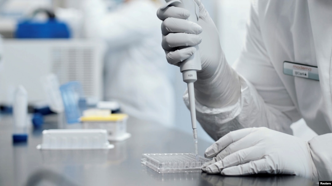 A researcher works in a lab run by Moderna Inc, in an undated still image from video.