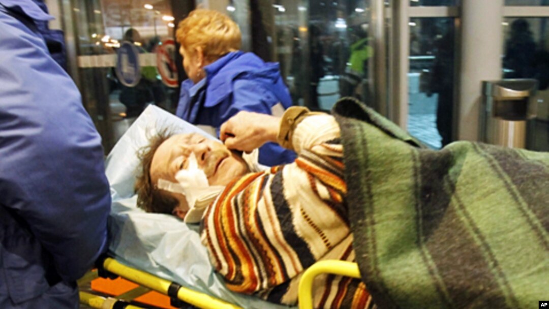 Medics wheel a victim of a bomb explosion at Moscow's Domodedovo airport, 24 Jan 2011
