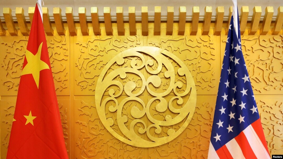 FILE - Chinese and U.S. flags are set up for a meeting in Beijing, April 27, 2018. 