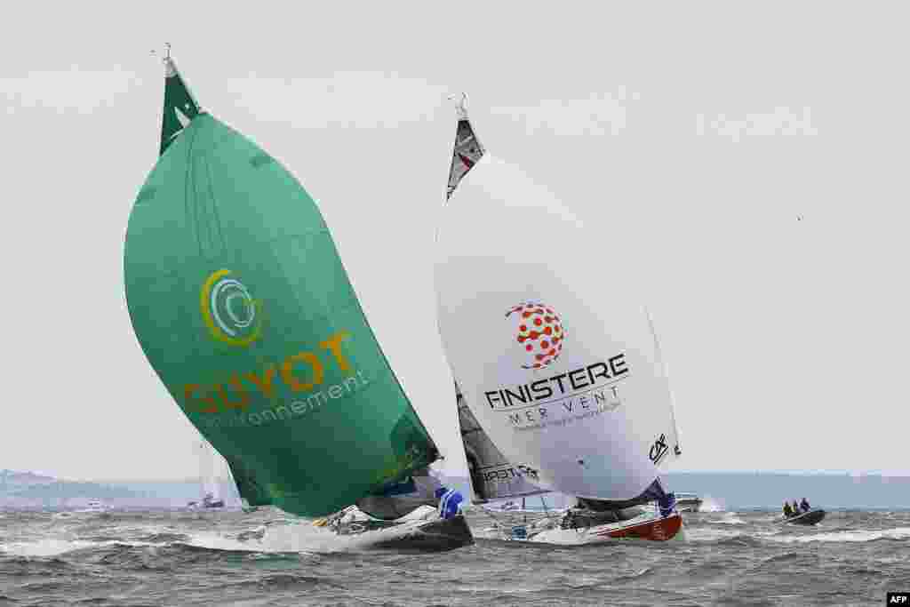 Pierre Leboucher (L) and Eric Peron sail on their monohulls "Guyot Environnement" and "Finistere Mer Vent" as they take the start of the 49th Solitaire URGO - Le Figaro solo sailing race off the coast of Le Havre, northwestern France.