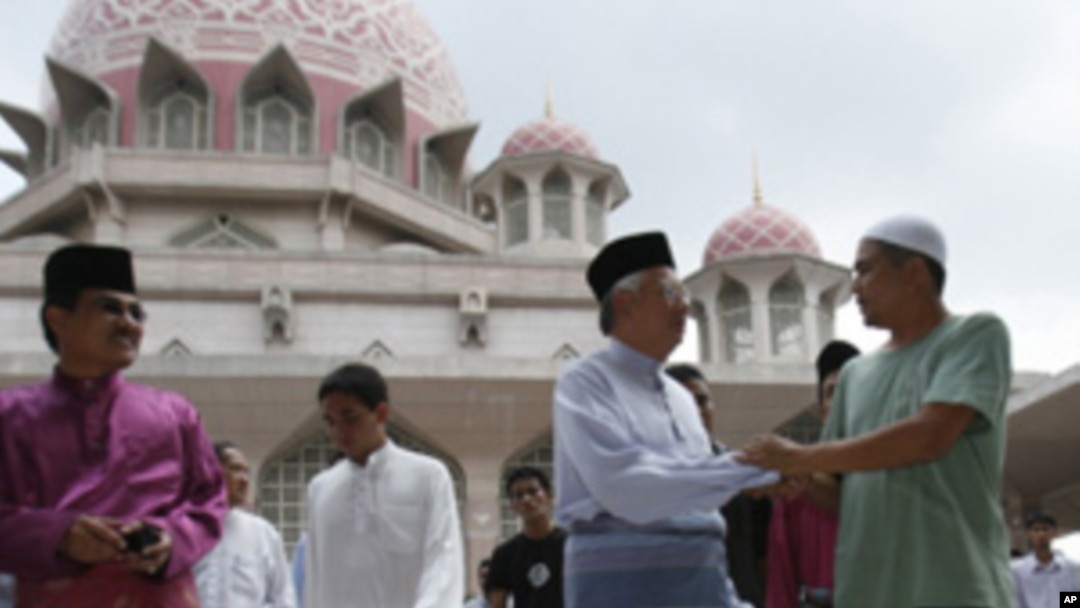Malaysia's Prime Minister Najib Razak (2nd R) meets people after Friday prayers at the Putra Mosque in Putrajaya outside Kuala Lumpur, 10 Jul 2010