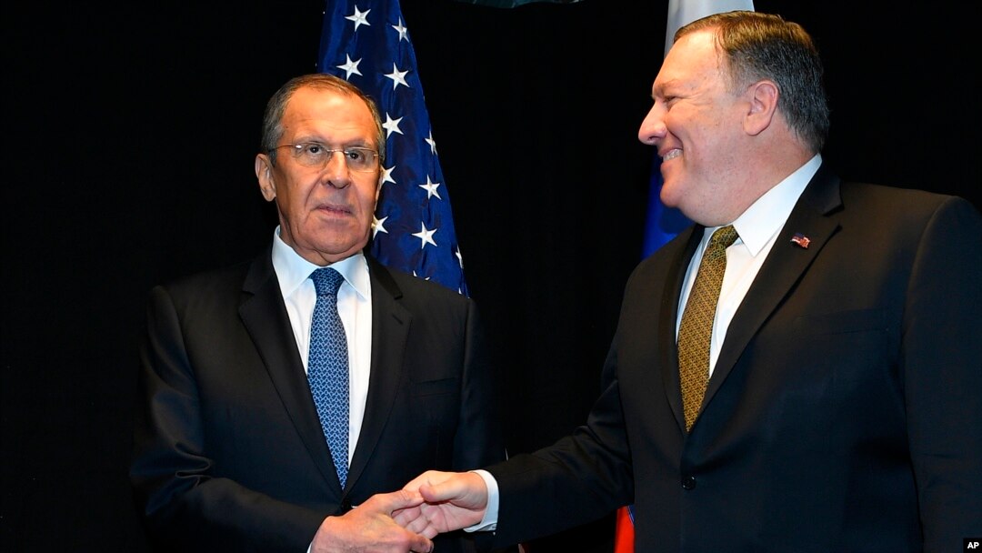 FILE - U.S. Secretary of State Mike Pompeo, right, shakes hands with Russia's Foreign Minister Sergey Lavrov as they meet on the sidelines of the Arctic Council Ministerial Meeting in Rovaniemi, Finland, May 6, 2019.