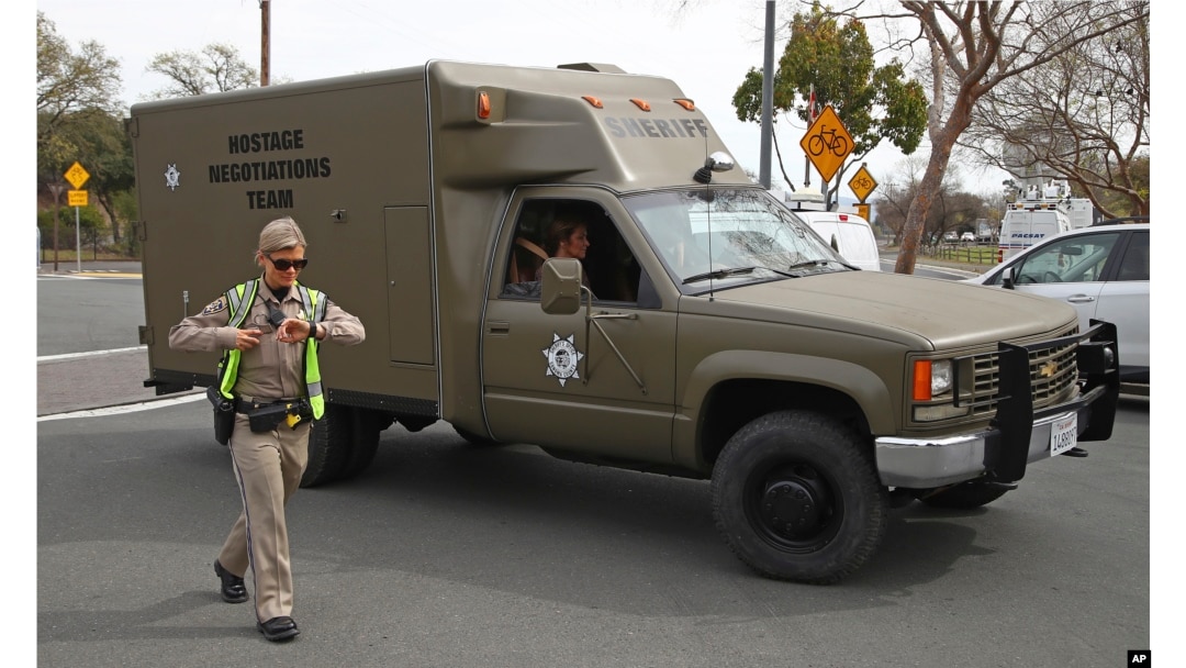 A sheriff's hostage negotiation team passes a California highway patrol checkpoint at the Veterans Home of California in Yountville, California, March 9, 2018.