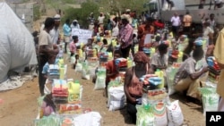 FILE - Men deliver aid donations from donors in Aslam, Hajjah, Yemen, Sept. 23, 2018.