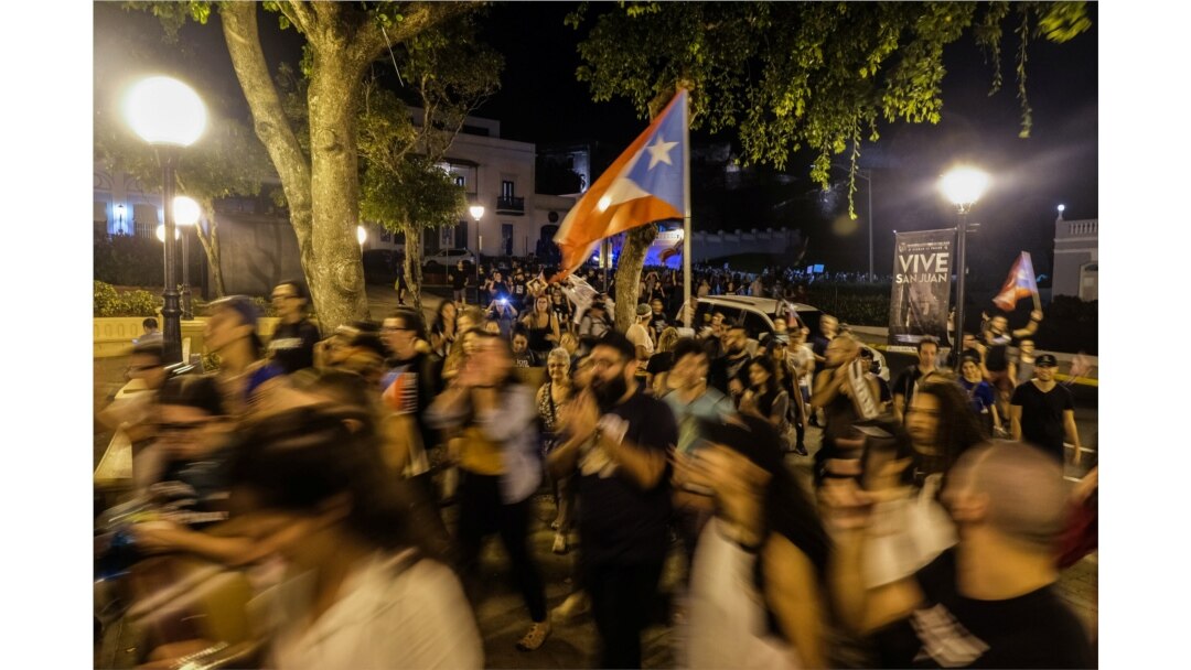 Protesters move the demonstration from the Capitol building to the Governors Mansion, after a warehouse full of relief aid dating back to Hurricane Maria was discovered, in San Juan, Puerto Rico, Jan. 20, 2020.