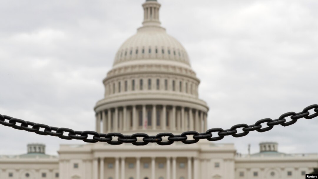 The dome of the U.S. Capitol is seen beyond a chain fence during the partial government shutdown in Washington, Jan. 8, 2019. 