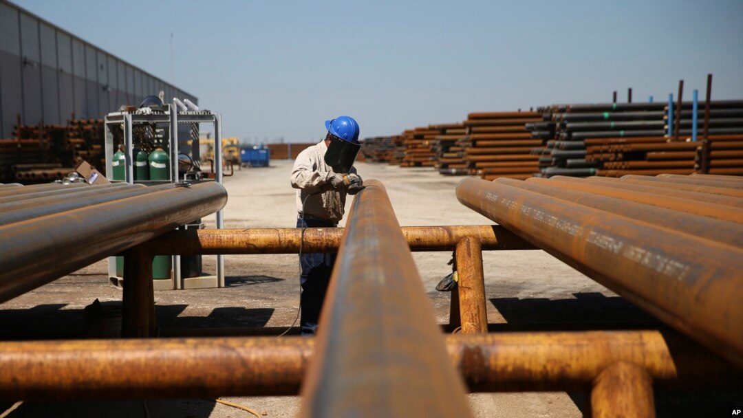 FILE - Jose Mata grinds a steel pipe at the Borusan Mannesmann plant in Baytown, Texas, April 23, 2018. Mexico and Canada imposed tariffs on various U.S. products last year in response to U.S. duties on steel and aluminum. 