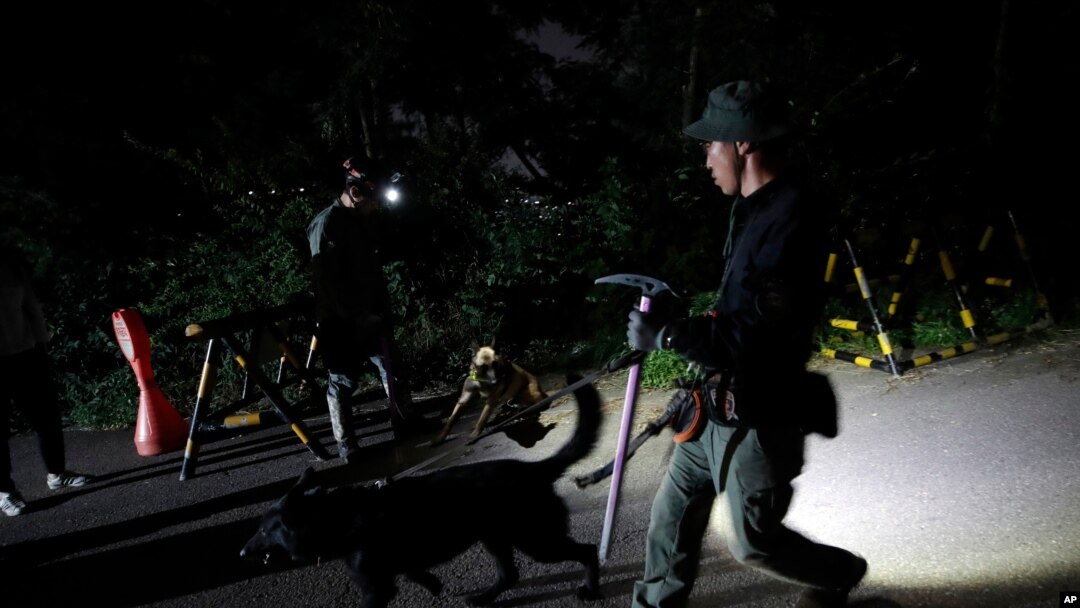 South Korean police officers with dogs leave to search for missing Seoul Mayor Park Won-soon in Seoul, South Korea, July 9, 2020.