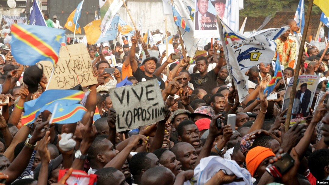 FILE - Supporters of Congolese opposition leader Etienne Tshisekedi carry placards and flags as they attend a political rally in the Democratic Republic of Congo's capital Kinshasa, July 31, 2016.