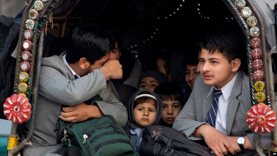 Pakistani students go to their school near Army Public School targeted by Taliban militants, in Peshawar, Pakistan, Monday, Jan. 12, 2015.