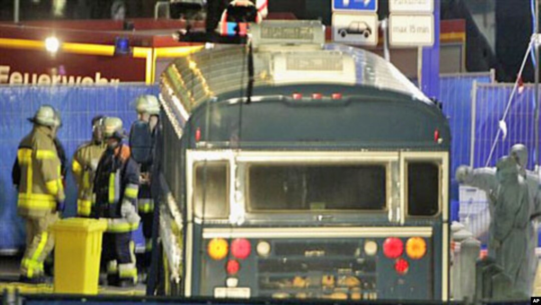 Police officers investigate the crime scene after a gunman fired shots at US soldiers on the bus outside Frankfurt airport, Germany, killing two airmen and wounding two before being taken into custody, March 2, 2011