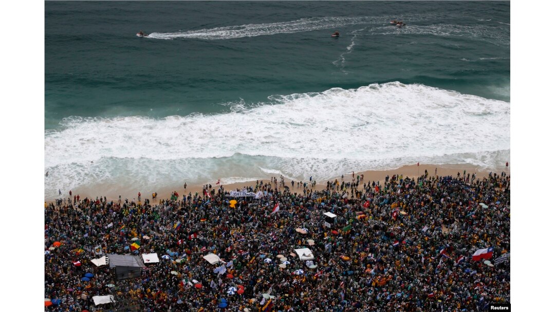 Lifeguards patrol offshore as Catholic pilgrims await the arrival of Pope Francis on Copacabana beach in Rio de Janeiro, Brazil, July 25, 2013.