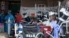 Health worker in a protective suit works in the makeshift emergency unit at Steve Biko Academic Hospital in Pretoria, South Africa, Jan. 11, 2021, which is battling an ever-increasing number of Covid-19 patients.
