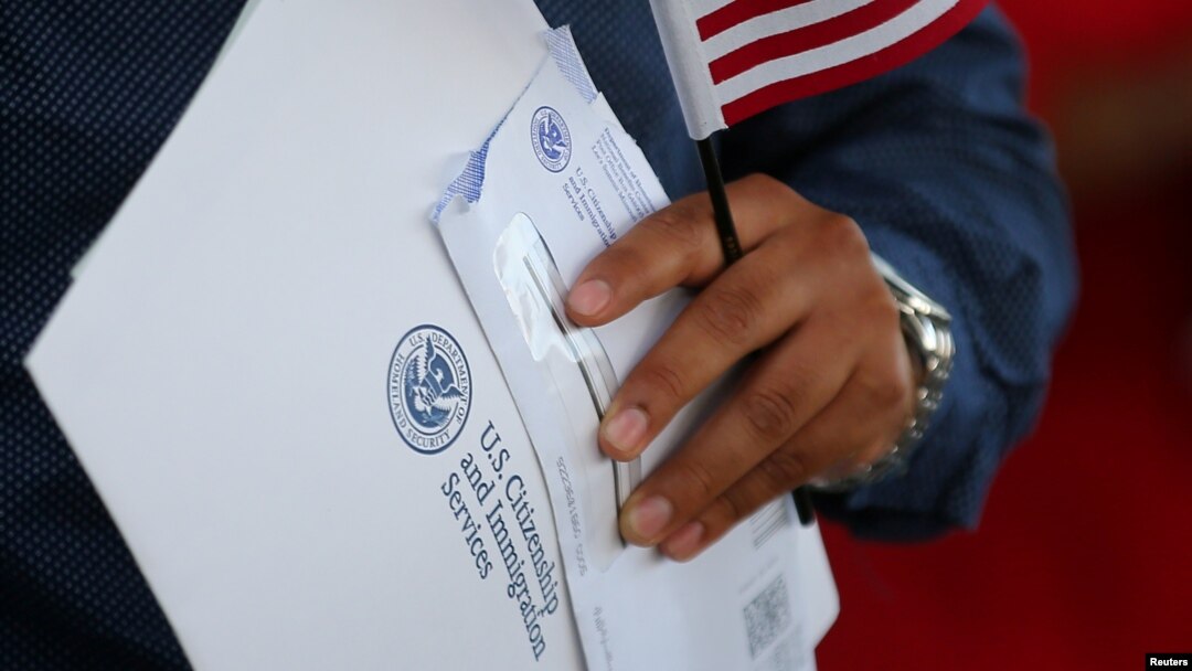 FILE - A newly naturalized U.S. citizen leaves a swearing in ceremony in Los Angeles, U.S., July 18, 2017. 