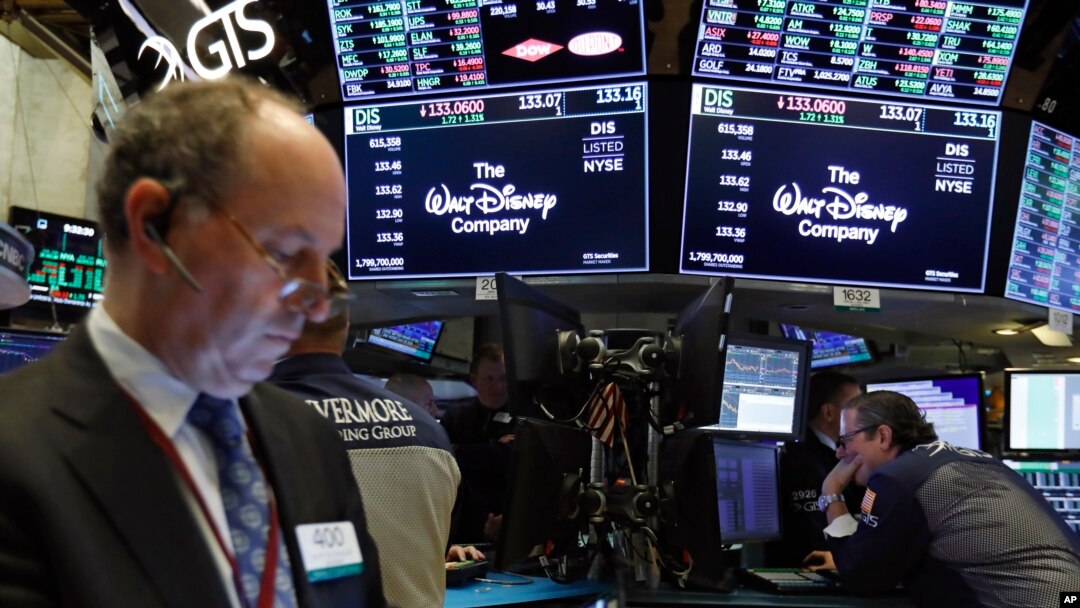 The logo for The Walt Disney Company appears above trading posts on the floor of the New York Stock Exchange, May 14, 2019. Disney is taking full control of Hulu, extending the reach of its streaming abilities.