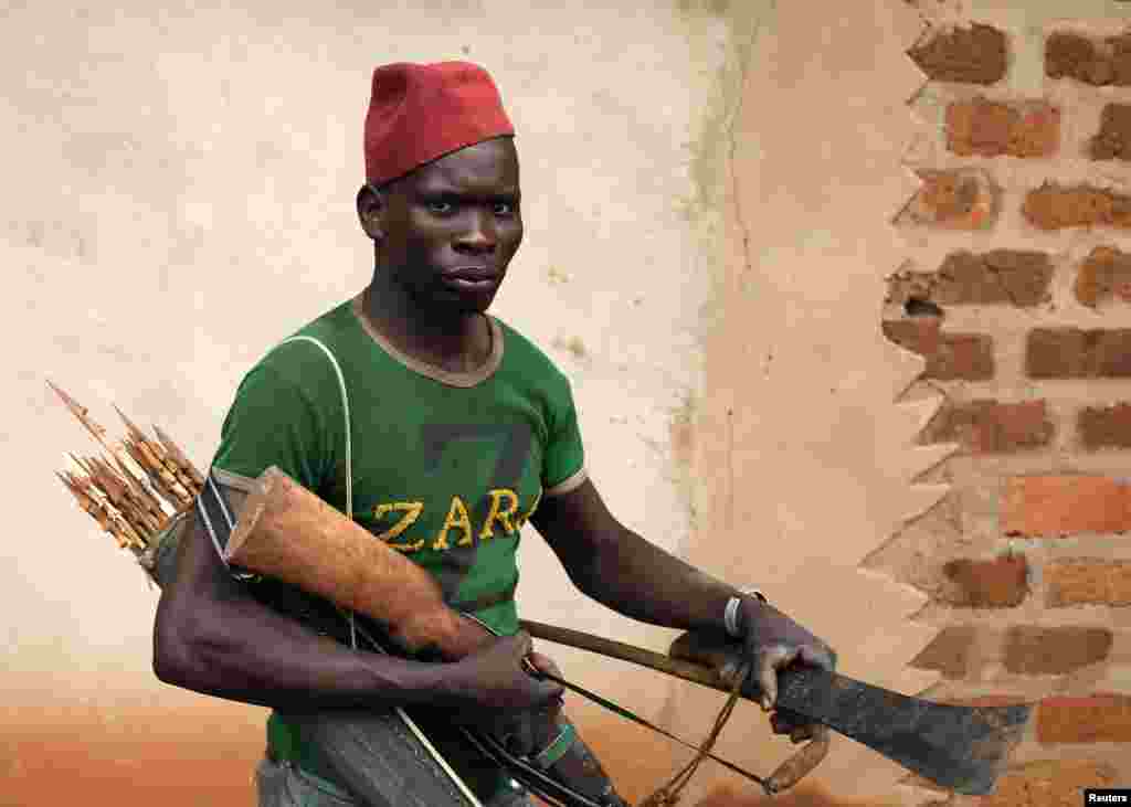 A member of the anti-balaka, a Christian militia, walks with his weapons in village of Zawa, Central African Republic, April 8, 2014.