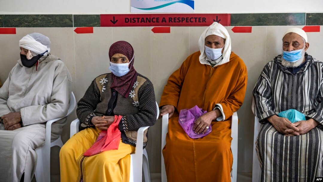 FILE - Moroccans wait their turn for the COVID-19 vaccine at an inoculation center in the city of Sale on February 12, 2021, as part of a campaign in the region.
