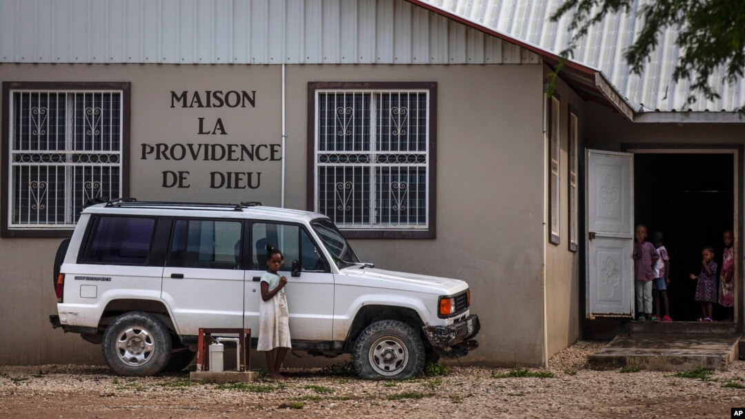 Children stand in the courtyard of the Maison La Providence de Dieu orphanage in Ganthier, Haiti, Sunday, Oct. 17, 2021, where a gang kidnapped 17 missionaries from a U.S.-based religious organization. (AP Photo/Joseph Odelyn)