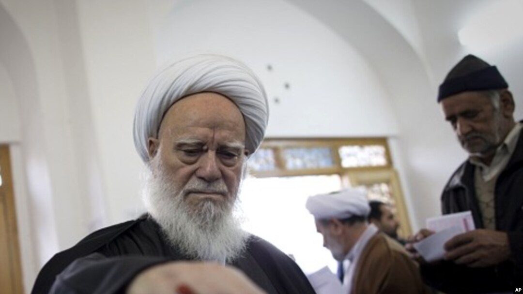 An Iranian clergyman casts his ballot at a polling station at Massoumeh shrine in the holy city of Qom, 130 kms south of Tehran, during parliamentary elections on March 2, 2012.