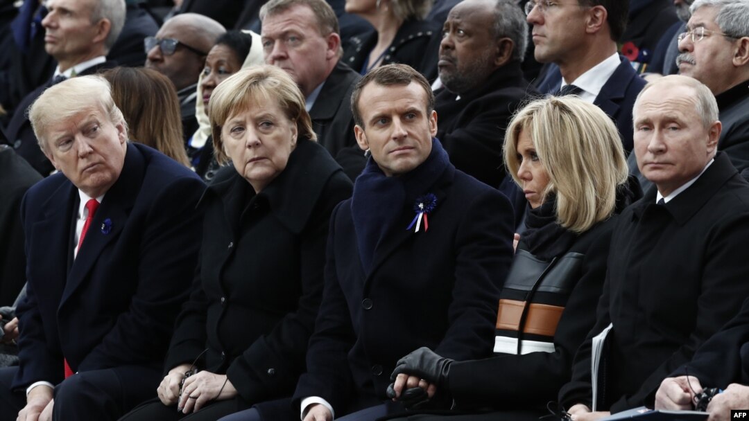 FILE - From left, President Donald Trump, German Chancellor Angela Merkel, French President Emmanuel Macron and his wife Brigitte Macron, and Russian President Vladimir Putin attend an Armistice Day ceremony in Paris, France, Nov. 11, 2018.