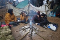 滞留在白俄罗斯与波兰边境的难民生火取暖。（美联社）