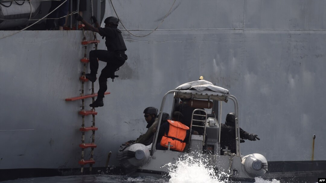 FILE - A Nigerian special guard climbs a ladder as he boards a vessel during a joint exercise between Nigerian and Moroccan naval personnel as part of a multinational maritime exercise off the coast of Lagos, March 20, 2019.