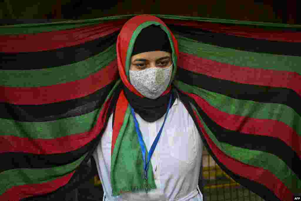 Afghans residing in India take part in a demonstration outside, the U.N. Refugee Agency office in New Delhi to protest against the Taliban's military takeover of Afghanistan.