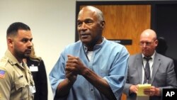 FILE - Former pro football star O.J. Simpson reacts after learning he was granted parole, at Lovelock Correctional Center in Lovelock, Nevada, July 20, 2017. 