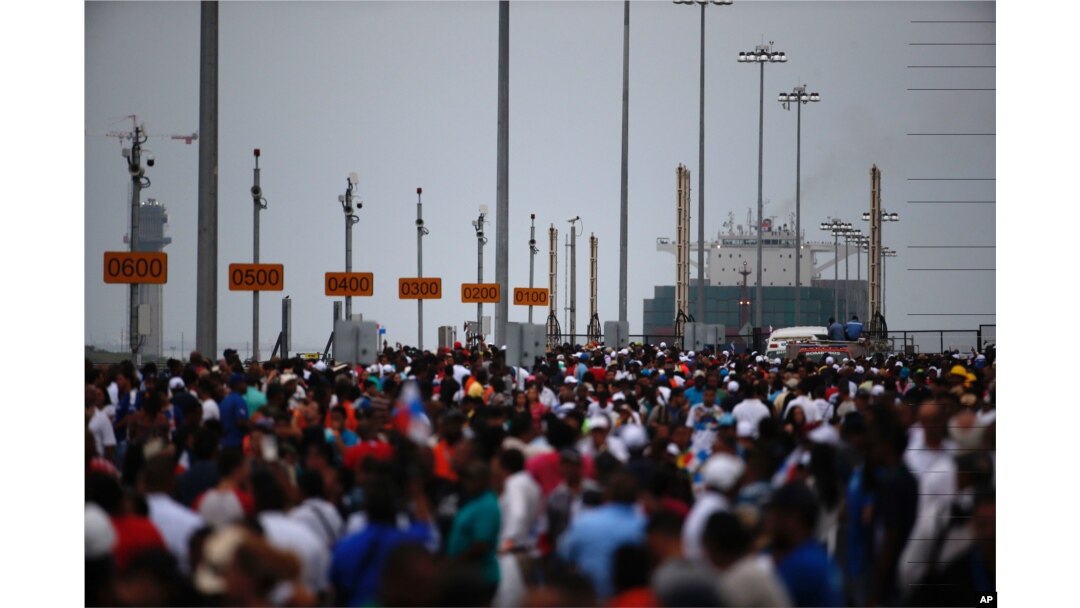 Thousands of spectators watch as the Neopanamax cargo ship, Cosco Shipping Panama, prepares to cross the new new Agua Clara locks, part of the Panama Canal expansion project, near the port city of Colon, Panama, June 26, 2016.
