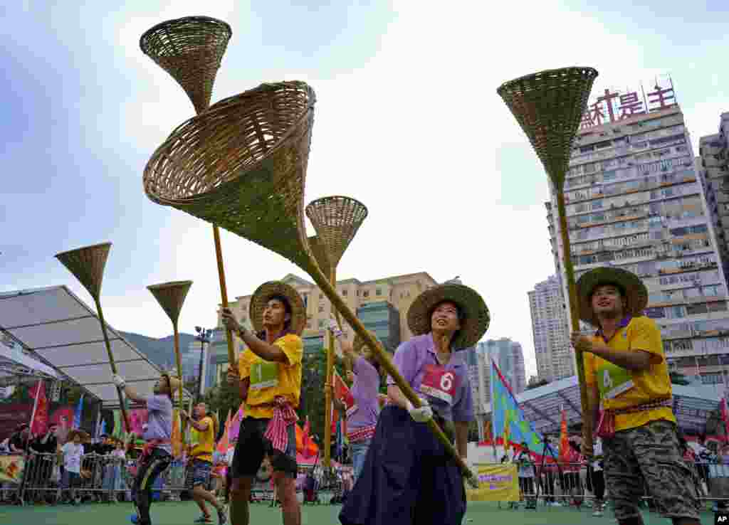 Participants try to catch rice during the Ghost Grappling competition to mark the "Hungry Ghost Festival" at a downtown park in Hong Kong.