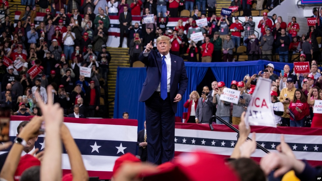 President Donald Trump points to the crowd after speaking during a campaign rally at UW-Milwaukee Panther Arena, Tuesday, Jan. 14, 2020, in Milwaukee.
