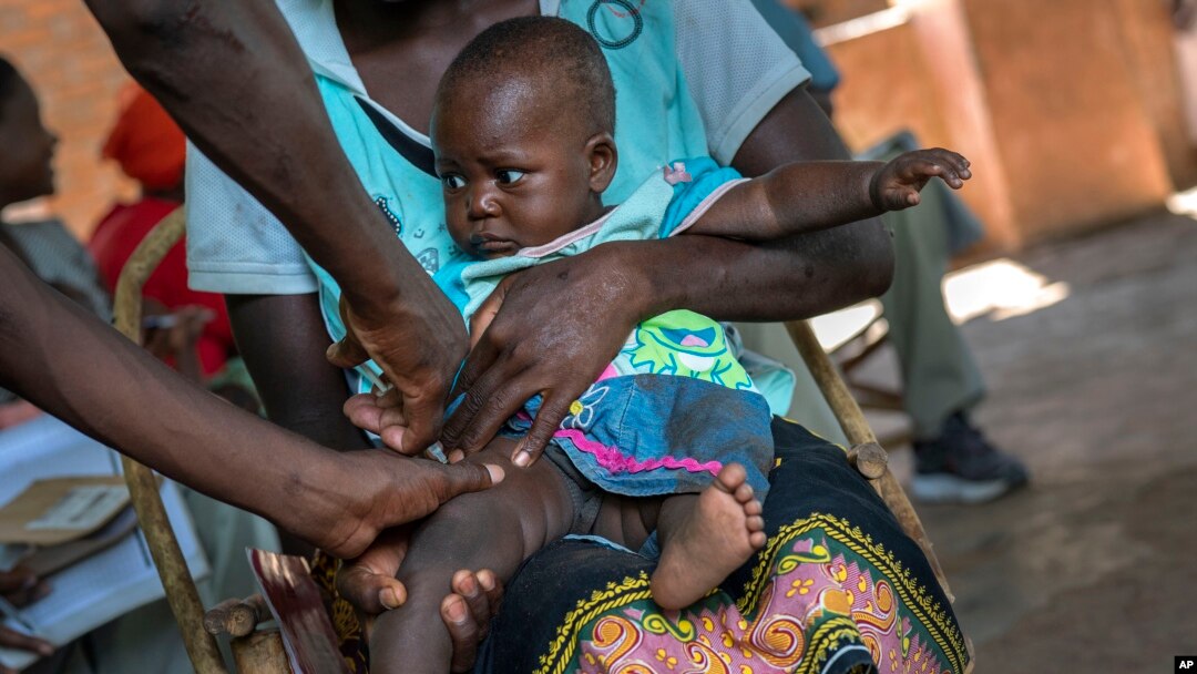 FILE - In this Wednesday, Dec. 11, 2019 file photo, a baby from the Malawi village of Tomali is injected with the world's first vaccine against malaria in a pilot program. WHO recommended the vaccine to curb the spread of the parasitic disease. (AP Photo/Jerome Delay, file)